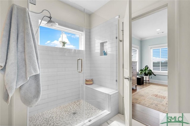 bathroom featuring crown molding and walk in shower