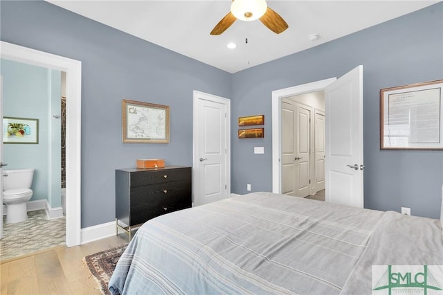 bedroom featuring a closet, ceiling fan, ensuite bathroom, and light hardwood / wood-style floors