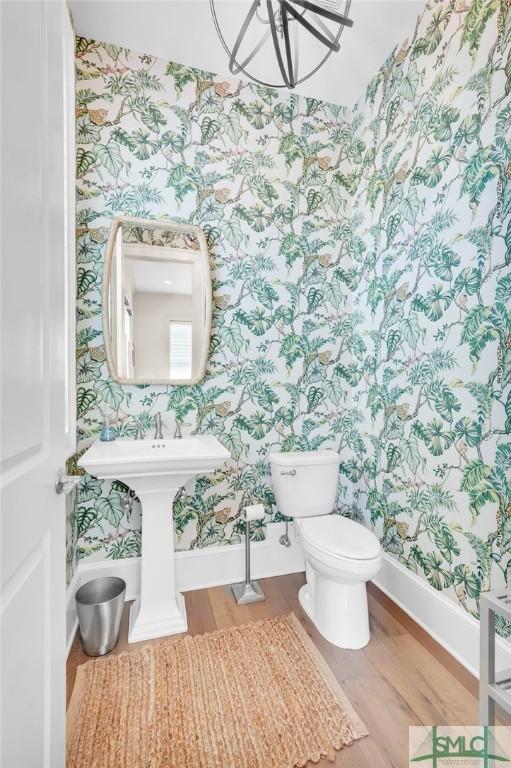 bathroom featuring hardwood / wood-style floors and toilet