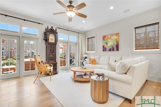 living room featuring ceiling fan and light wood-type flooring