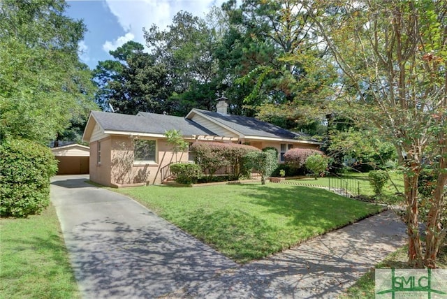 single story home with a chimney, a front yard, and stucco siding