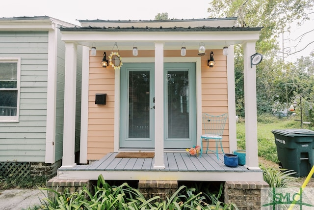 view of exterior entry featuring a porch