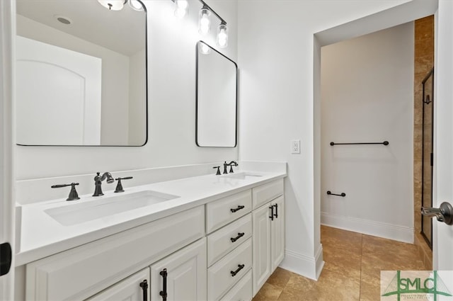 bathroom with vanity and a shower with shower door