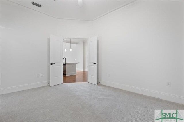 unfurnished bedroom featuring light carpet and ceiling fan