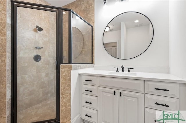 bathroom with walk in shower and vanity