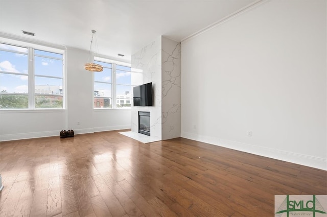 unfurnished living room with hardwood / wood-style floors and a premium fireplace