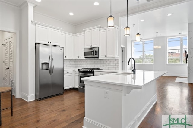 kitchen featuring pendant lighting, dark hardwood / wood-style floors, sink, white cabinetry, and appliances with stainless steel finishes