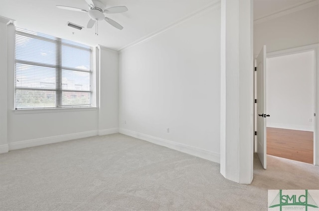 carpeted spare room featuring ornamental molding and ceiling fan