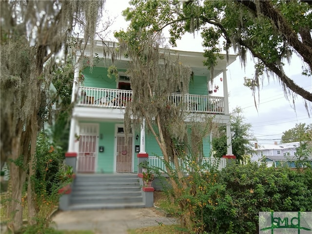 view of front of house with a balcony and covered porch