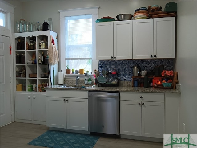 kitchen featuring white cabinets, dishwasher, and plenty of natural light