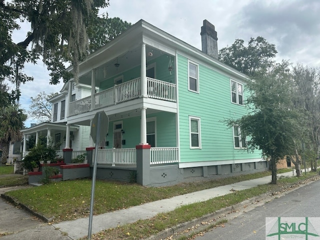 view of home's exterior featuring a balcony and a porch