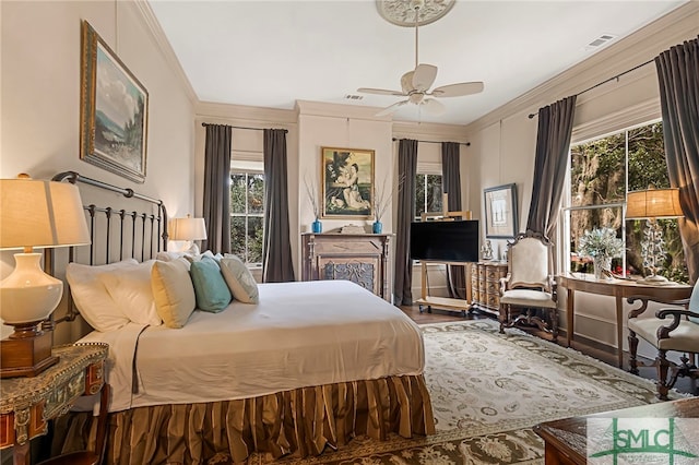 bedroom with multiple windows, ceiling fan, and crown molding