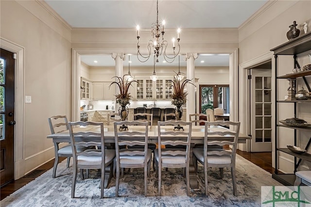 dining room featuring a notable chandelier, crown molding, and dark hardwood / wood-style flooring