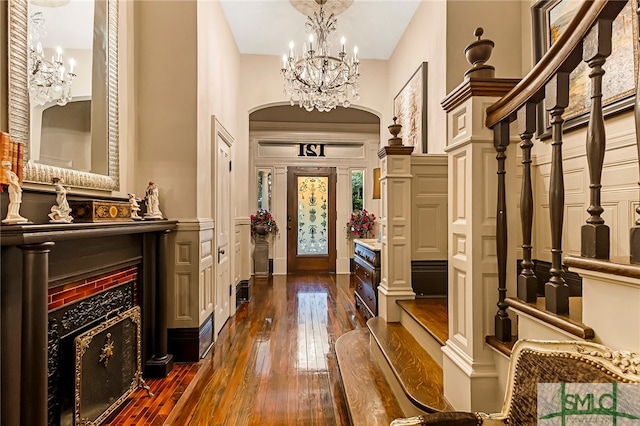 foyer with an inviting chandelier and dark hardwood / wood-style floors