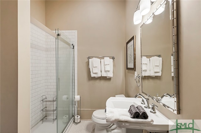 bathroom featuring a shower with shower door, toilet, and tile patterned floors