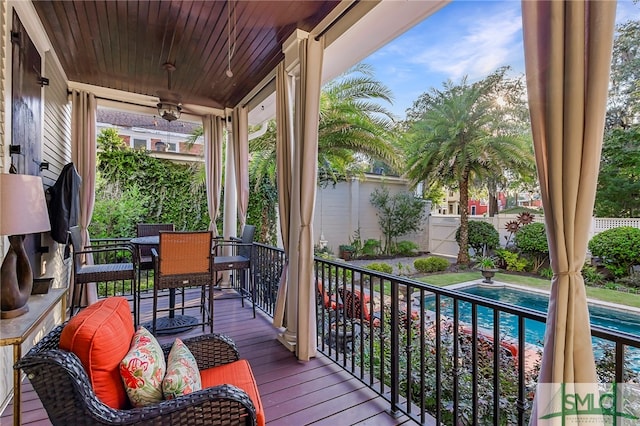 deck featuring a fenced in pool