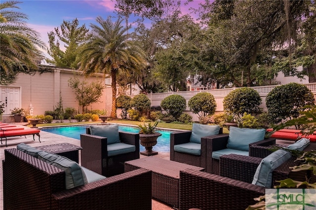 pool at dusk with a patio