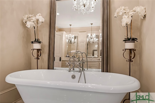 bathroom with an inviting chandelier and a bath