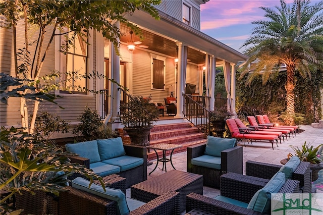 patio terrace at dusk featuring an outdoor living space