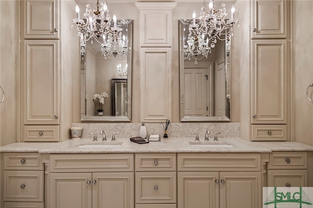 bathroom with vanity and a chandelier