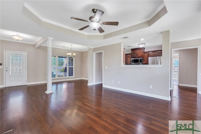 unfurnished living room with a tray ceiling, crown molding, dark wood-type flooring, and ornate columns