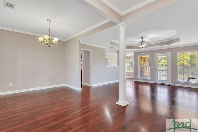 unfurnished room with a tray ceiling, decorative columns, ceiling fan with notable chandelier, crown molding, and dark hardwood / wood-style flooring