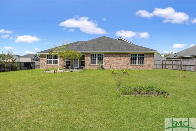 rear view of property with a yard