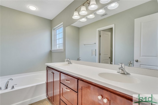 bathroom featuring tile patterned flooring, vanity, and a washtub