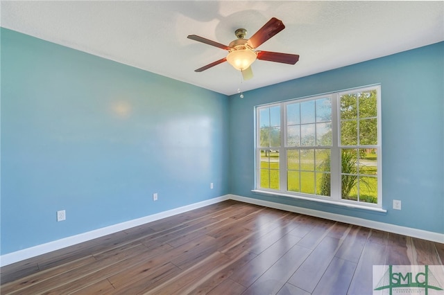 empty room featuring ceiling fan, dark hardwood / wood-style floors, and a textured ceiling