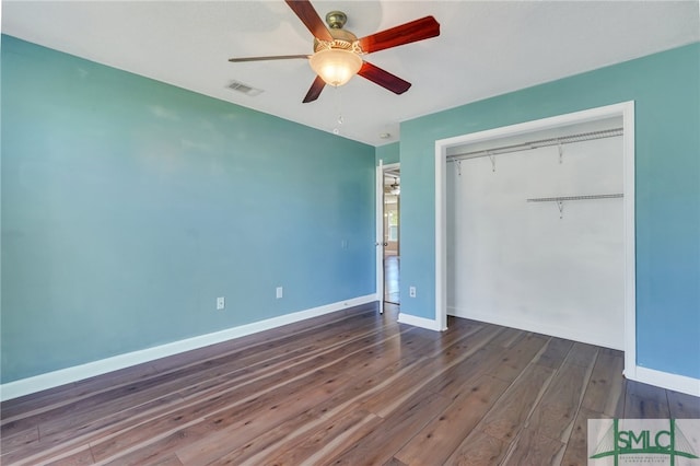 unfurnished bedroom featuring a closet, ceiling fan, and dark wood-type flooring