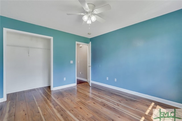 unfurnished bedroom with ceiling fan, light hardwood / wood-style flooring, and a closet