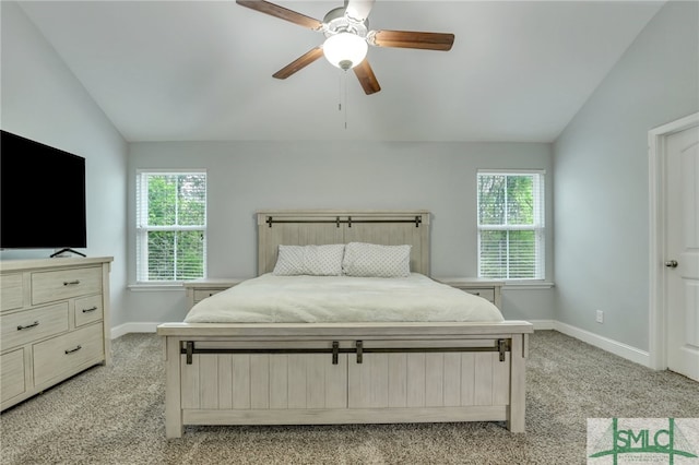 carpeted bedroom with vaulted ceiling, multiple windows, and ceiling fan