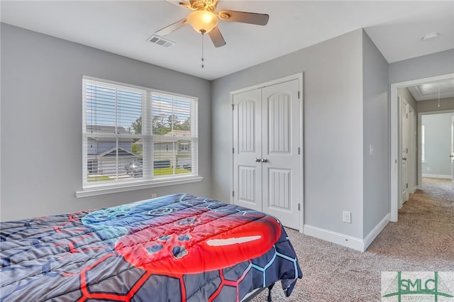 bedroom with a closet, ceiling fan, and carpet flooring