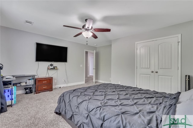 bedroom with ceiling fan, carpet floors, and a closet