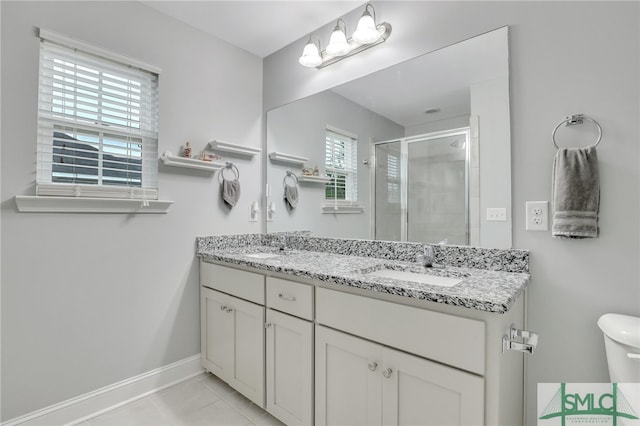 bathroom with vanity, tile patterned floors, a shower with shower door, and toilet