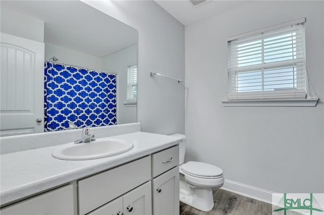 bathroom featuring hardwood / wood-style floors, vanity, and toilet