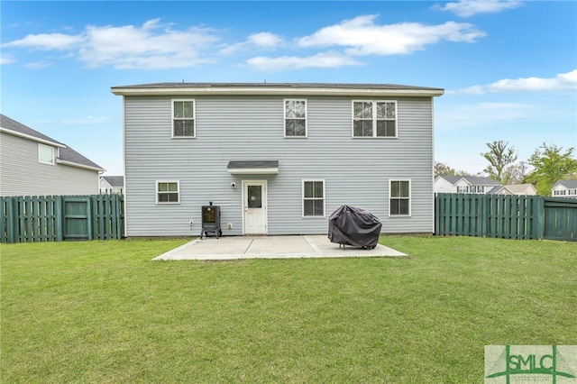 rear view of property featuring a lawn and a patio area