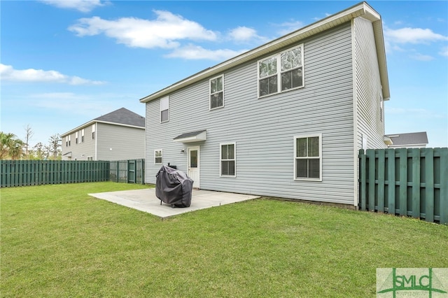 rear view of property with a lawn and a patio area