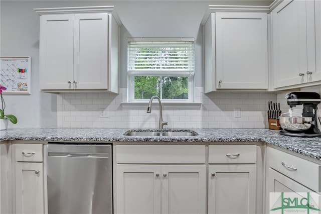 kitchen with decorative backsplash, white cabinetry, dishwasher, and sink