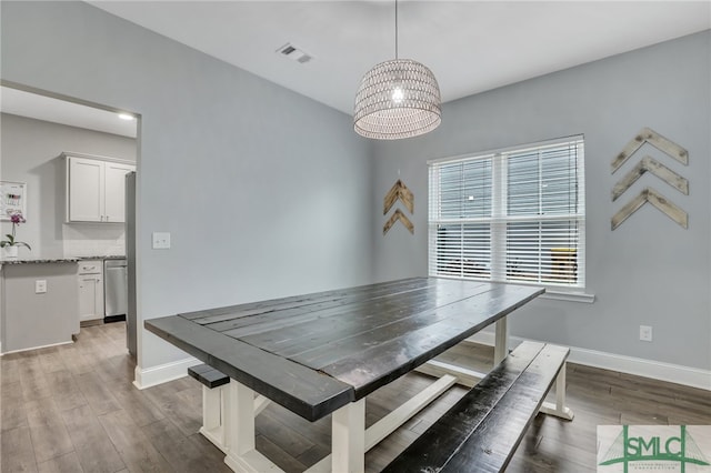 dining room with a notable chandelier and hardwood / wood-style floors