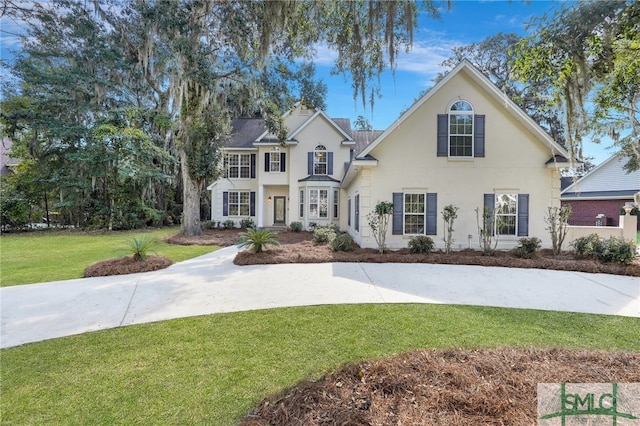 colonial home with a front yard