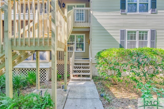 view of exterior entry with a wooden deck