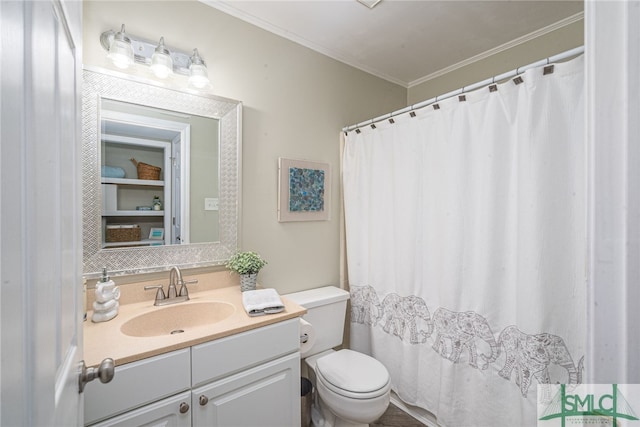 bathroom with crown molding, vanity, and toilet