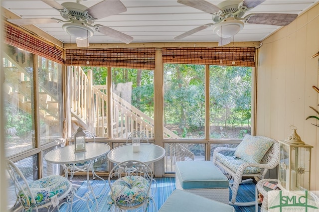 sunroom / solarium with ceiling fan and a healthy amount of sunlight