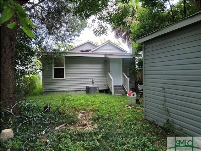 rear view of property featuring central AC