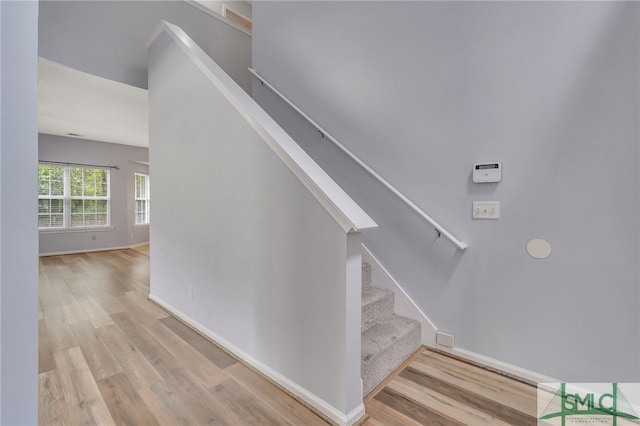 stairs featuring wood-type flooring