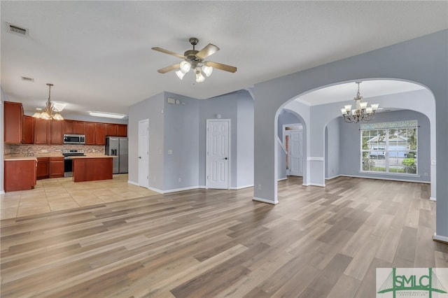 unfurnished living room with light hardwood / wood-style flooring, a textured ceiling, ceiling fan with notable chandelier, and sink