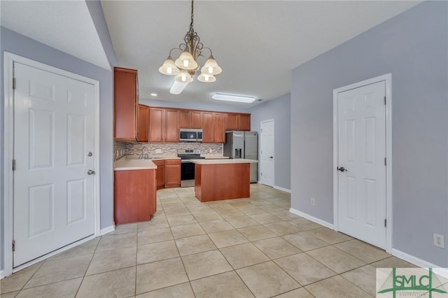 kitchen featuring hanging light fixtures, stainless steel appliances, an inviting chandelier, a center island, and sink