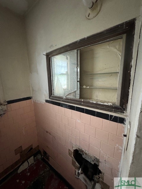 bathroom with tile walls