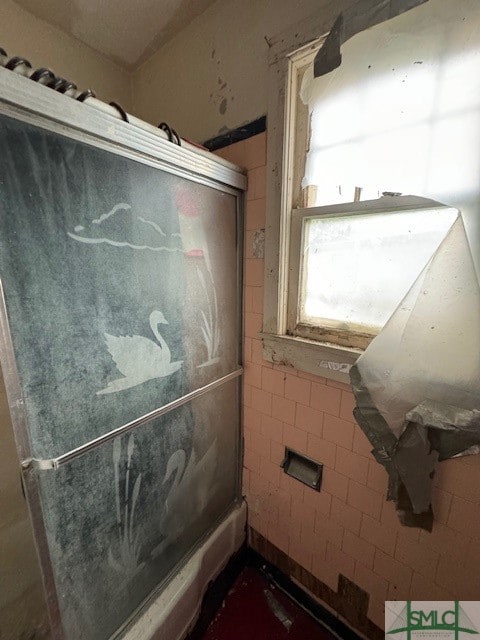 bathroom with tile walls